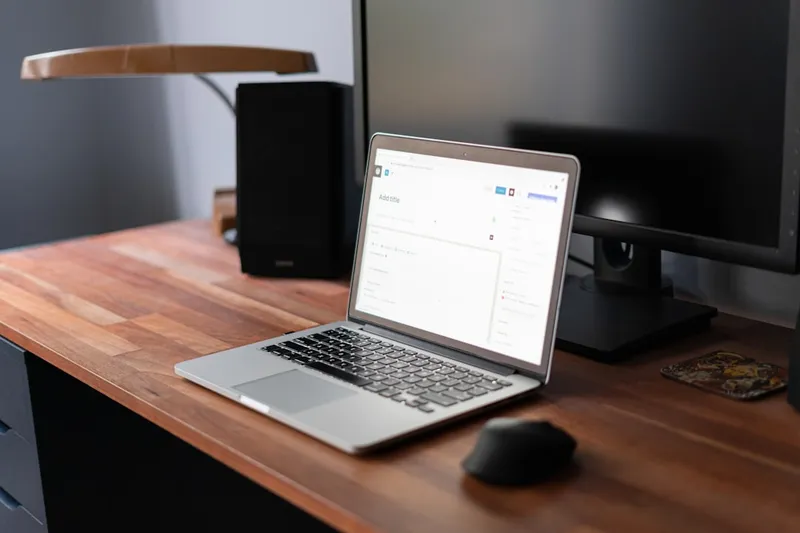 Two laptops on a desk for comparing AI video clipping tools