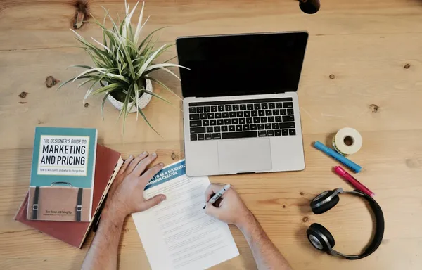 MacBook Pro and headphones on desk for content strategy planning